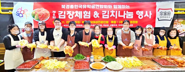 북경에서 열린 '제5회 김장체험 & 김치나눔 행사'에서 권영자 북경한국여성전문인회 회장(사진 오른쪽에서 여섯번째)과 회원들이 학생들과 함께 김치를 담그며 기념촬영을 하는 모습.  