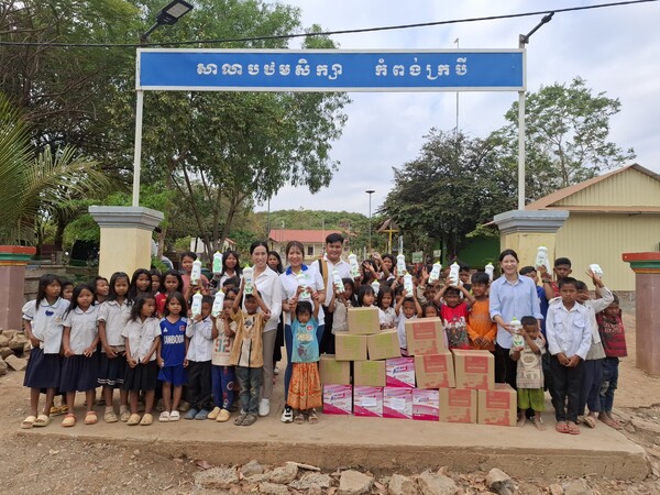 캄보디아 깜퐁톰주 바라이군 소재 끄로바이 초등학교 앞에서 아이들과 함께 기념 촬영중인 스롱 파아비 선수(가운데). [박정연 재외기자]